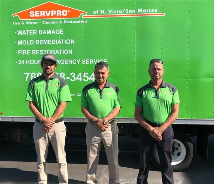 Juan , Joe, Steve, SERVPRO owners in front of SERVPRO green truck